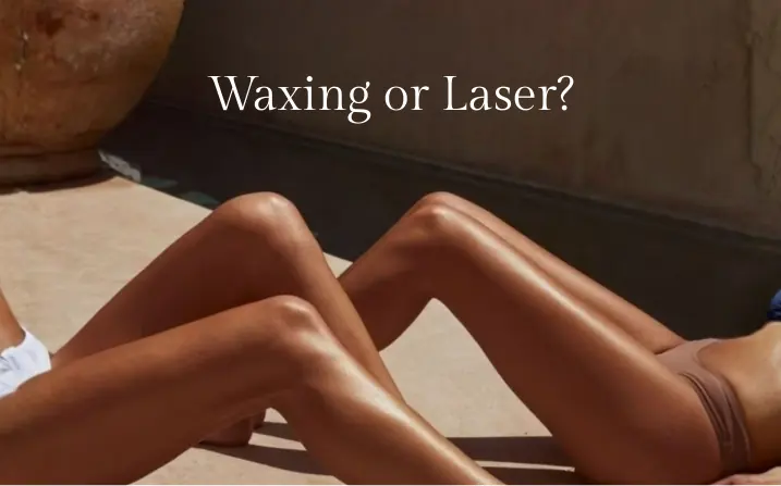 Editorial cover reading 'Waxing or Laser?' — smooth, sunlit bare legs resting on a warm sandstone floor beside a weathered terracotta urn, set against a moody clay-coloured wall at The Wellness Ed.